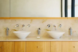 Modern bathroom with double sinks and mirrors.