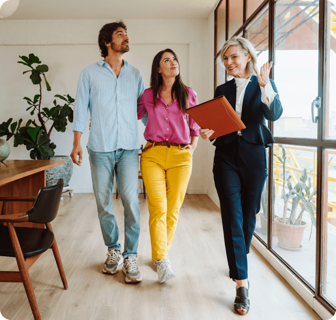 Real estate agent showing couple a property.