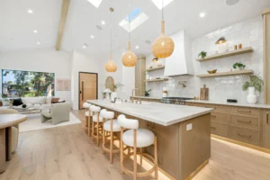 Modern kitchen with island and pendant lights.