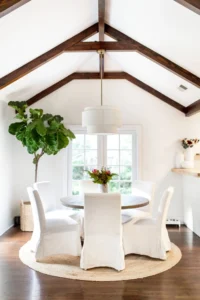 Bright dining room with vaulted wooden ceiling.