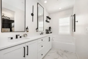 Minimalist white bathroom with modern fixtures.